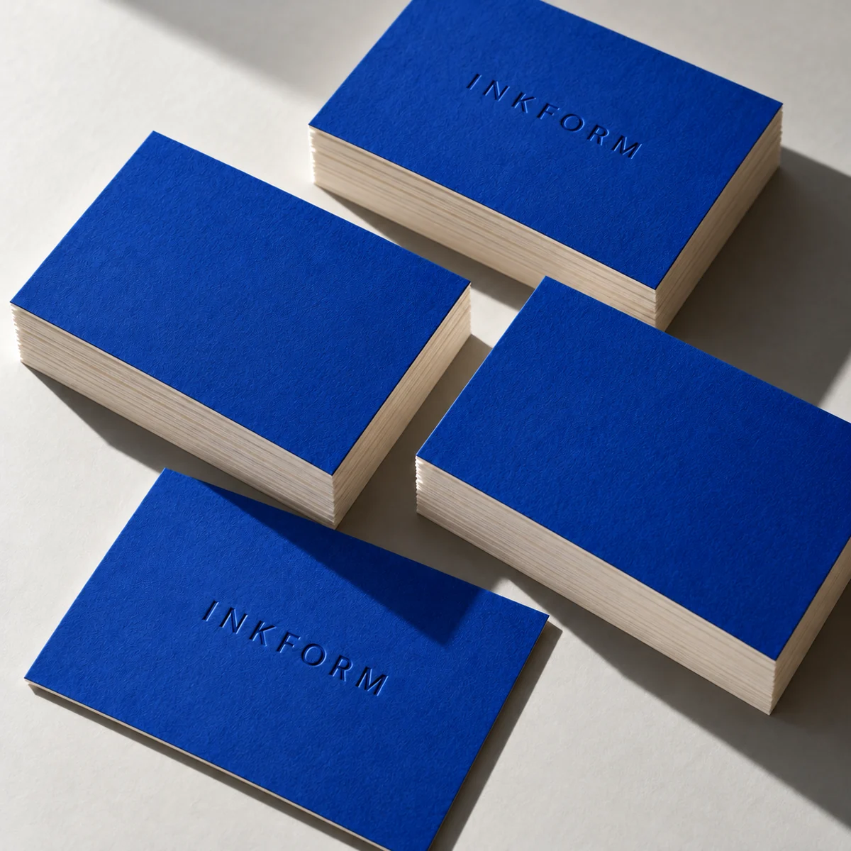 AI concept of blue and ivory INKFORM business cards